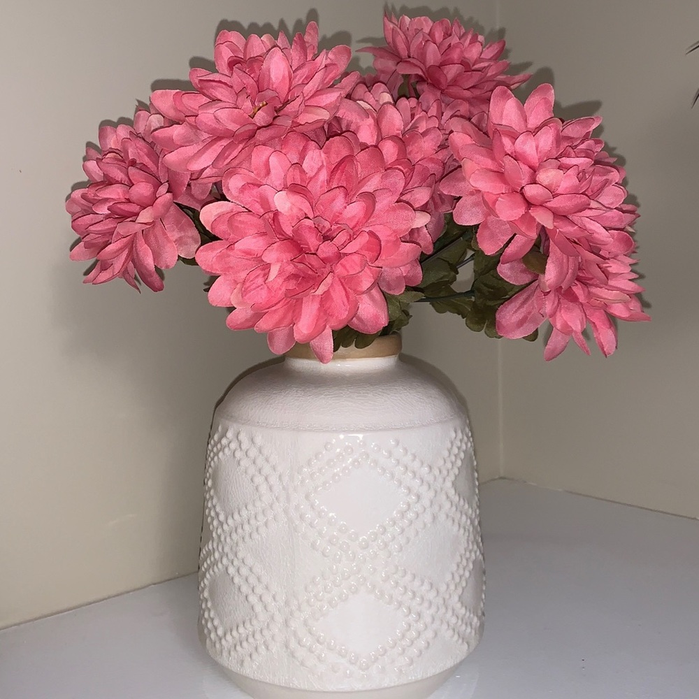 White vase with pink flowers